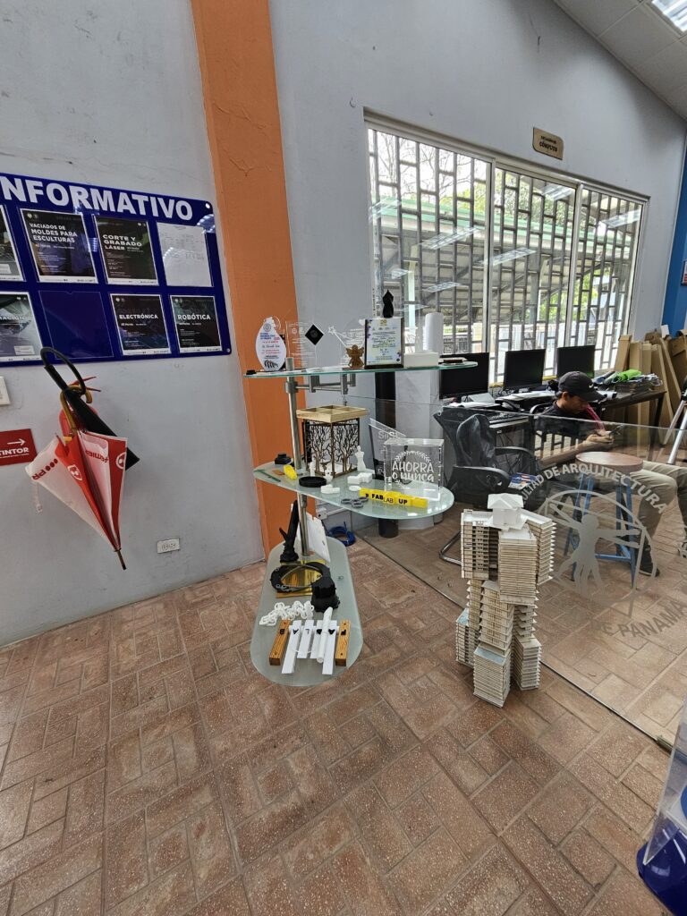 The entrance area of the University of Panaman makerspace, displaying numerous awards and achievements